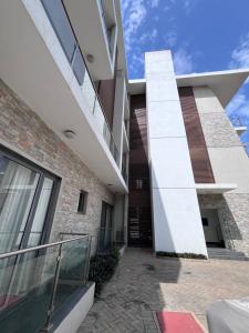 an external view of a building with a staircase at Avant Garde Luxury Apartment in Accra