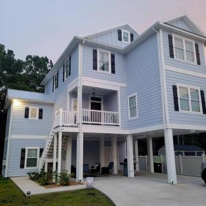a large white house with a porch and balcony at Dreamy Palms in Myrtle Beach