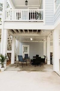a porch with chairs and a table on a house at Dreamy Palms in Myrtle Beach