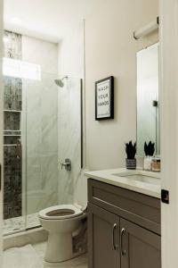 a bathroom with a shower and a toilet and a sink at Dreamy Palms in Myrtle Beach +27 photos