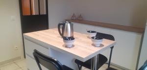 a counter with two chairs and a blender on it at La Giraudière in Cellettes +4 photos