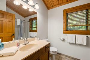 a bathroom with a sink and a toilet at 803 Mountain Cabin in Boyne Falls +26 photos