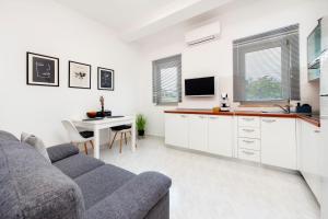 a living room with a couch and a table at Apartman NEVERA in Rovinj