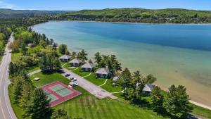 an aerial view of a house on the shore of a lake at 803 Mountain Cabin in Boyne Falls