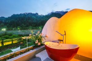 a bathroom with a tub and a view of a mountain at Pure House in Zhangjiajie