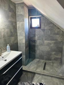 a bathroom with a sink and a window at Casa Cristina in Tuzla