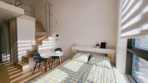 a bedroom with a bed and a table and chairs at 서울의 야경을 품은 스테이 in Seoul
