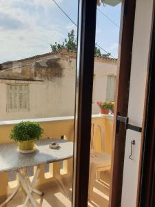 a view of a balcony with a table and a window at Beautiful house in Aegina in Egina