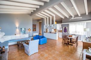 a living room with a blue couch and a table at Cleo beachfront villa in Potos +37 photos