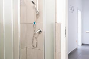 a shower in a bathroom with a glass door at Sole & Pepe in Santa Maria di Castellabate