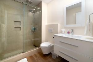 a bathroom with a shower and a toilet and a sink at Bright, Newly Remodeled 1BR in PA Second Downtown in Palo Alto