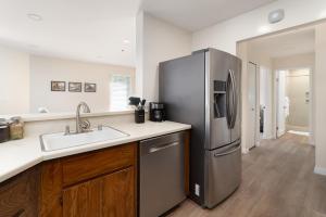 a kitchen with a stainless steel refrigerator and a sink at Bright, Newly Remodeled 1BR in PA Second Downtown in Palo Alto