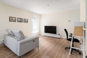 a living room with a couch and a flat screen tv at Bright, Newly Remodeled 1BR in PA Second Downtown in Palo Alto