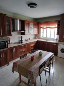 a kitchen with a table with chairs and a sink at Casa Capi in La Orotava