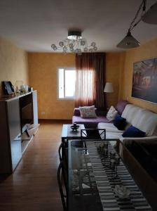 a living room with a couch and a table at Casa Capi in La Orotava