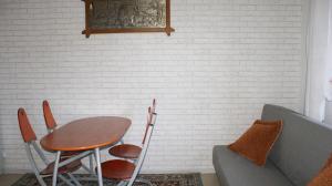 a room with a table and chairs and a couch at Domek pod różą in Krasnobród