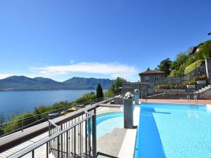 a swimming pool with a view of a body of water at Apartment by Lake Maggiore with Stunning View in Oggebbio