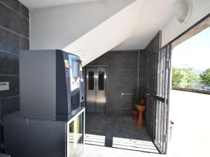 a hallway with a tv and a door in a building at Apartment by Lake Maggiore with Stunning View in Oggebbio
