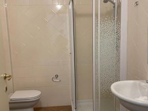 a bathroom with a shower and a toilet and a sink at Apartment by Lake Maggiore with Stunning View in Oggebbio +26 photos