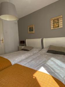 two beds sitting next to each other in a bedroom at Apartamento Zurbarán in Irún +25 photos