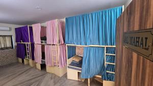 a room with a row of bunk beds with curtains at Jaipur View in Jaipur +62 photos