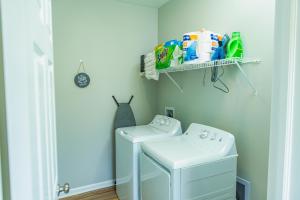 a laundry room with a washer and dryer at 2 Story New Build 4 Miles to Downtown 3 Miles to Speedway 8 Miles to Airport in Indianapolis +14 photos
