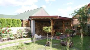 a pavilion in a garden with a fence at Domek pod różą in Krasnobród +10 photos