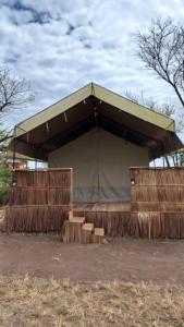 a large tent with steps in front of it at Green Garden Serengeti Luxury Tented Camp in Banagi