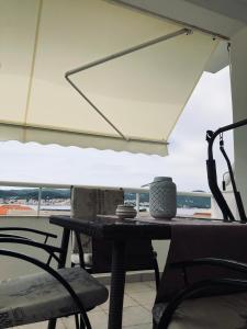 a table and chairs with a view of the ocean at Apartments Jadra in Kučište