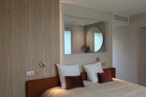 Postel nebo postele na pokoji v ubytování Hôtel Les Fines Gueules