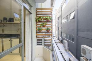 a balcony with potted plants on a stair case at JAO32 - 1 Suíte, TV Smart, Wi-Fi in Balneário Camboriú +13 photos