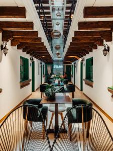 a restaurant with tables and chairs in a building at Selah Hotel & Coffee in Antigua Guatemala