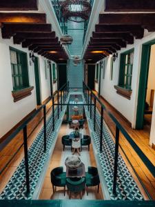an empty corridor of a building with tables and chairs at Selah Hotel & Coffee in Antigua Guatemala