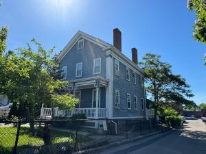 uma casa cinzenta com duas chaminés numa rua em Beautiful Victorian house, Room em Boston