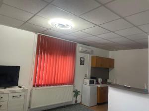 a kitchen with a red curtain and a red window at Panorama Studio Sighisoara in Sighişoara