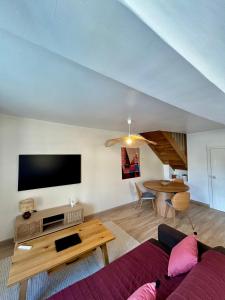a living room with a couch and a table at La Cassine bis - Havre de paix à Saint Ceneri in Moulins-le-Carbonnel +6 photos