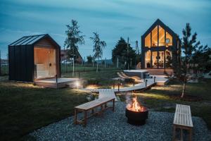 a house with a fire pit in the yard at Békés Bucka Mátra in Parád