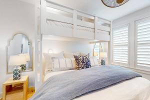 a bedroom with a white bunk bed and a mirror at Ocean Pearl at Palmilla Beach in Port Aransas +47 photos