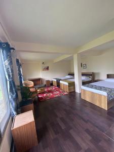 a large room with two beds and a couch at 18 Soesunn in Māngwa