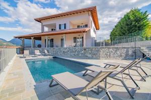 a villa with a swimming pool and a house at VILLA DEI VENTI NORTH by Curtiaffitti in Pianello Del Lario