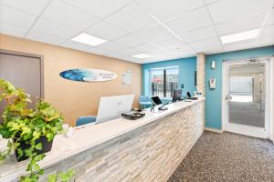 an office lobby with a reception desk and airus sign on the wall at The Waves Hotel, Ascend Hotel Collection in Wildwood