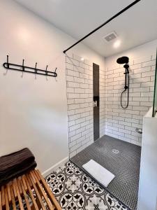 a bathroom with a shower with black and white tile at Canterbury Suites B&B in Bar Harbor
