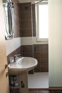 a bathroom with a sink and a window at BluApartments 3,Shëngjin Seaview in Shëngjin