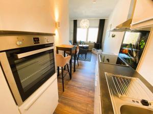 a kitchen with a sink and a stove top oven at Peters Aparthotel in Goslar