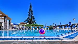 a pool with a beach ball in the water at Villa Mare Monte ApartHotel in Malia
