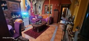 a living room with a purple couch and a table at Sylvias Antique House in Nicosia