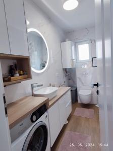 a bathroom with a washing machine and a sink at Lumani Apartment Zagreb with FREE Parking in Zagreb