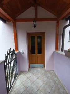a entrance to a house with a wooden door at Apartman EMA in Kulen Vakuf