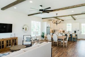 a dining room and living room with white walls and wooden ceilings at Kaya Cottages in Dahlonega