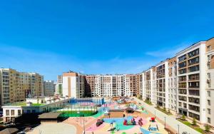 an apartment complex with a swimming pool in a city at Manhattan 5 Astana city in Taldykolʼ